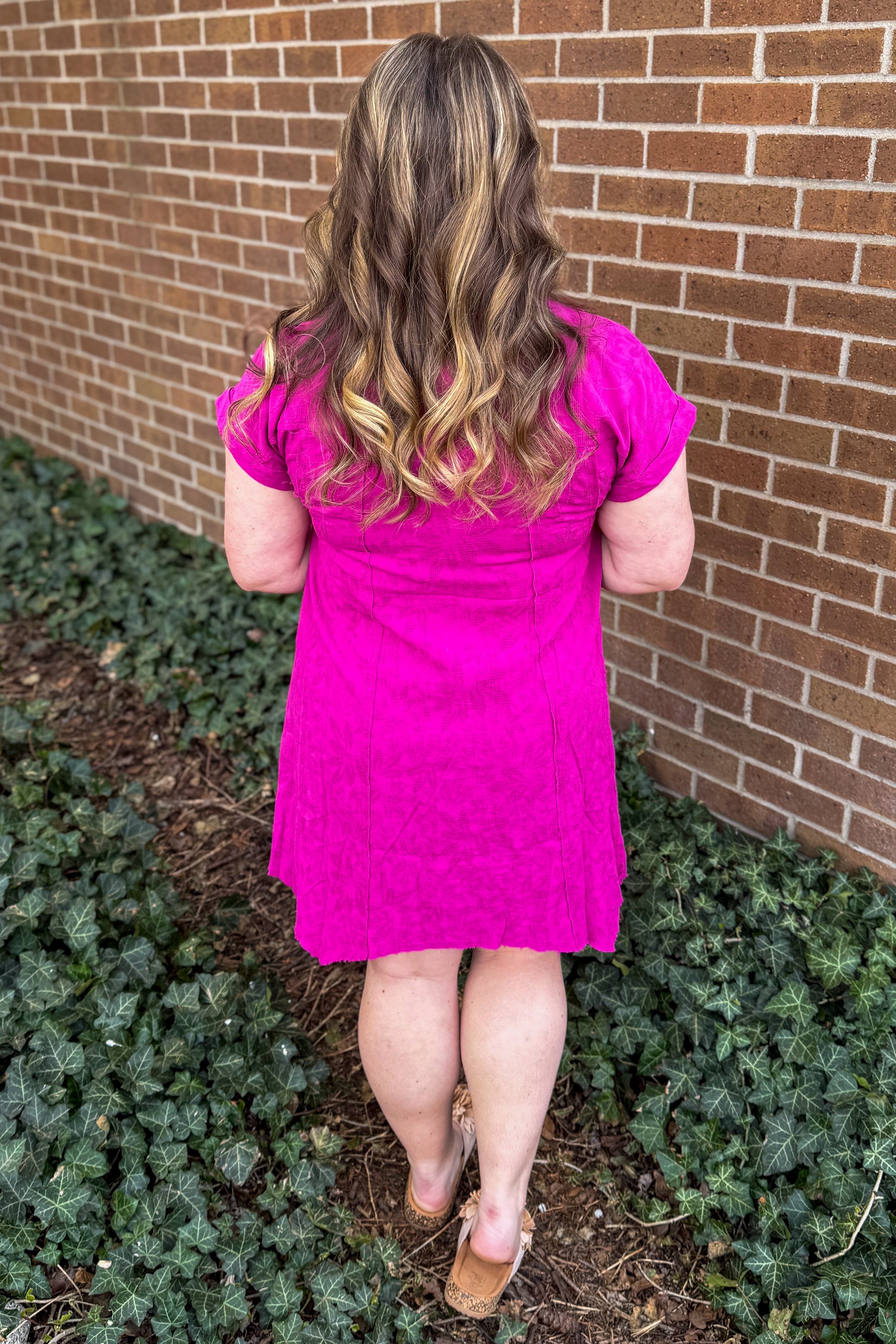 fuchsia shark bite hem dress. back