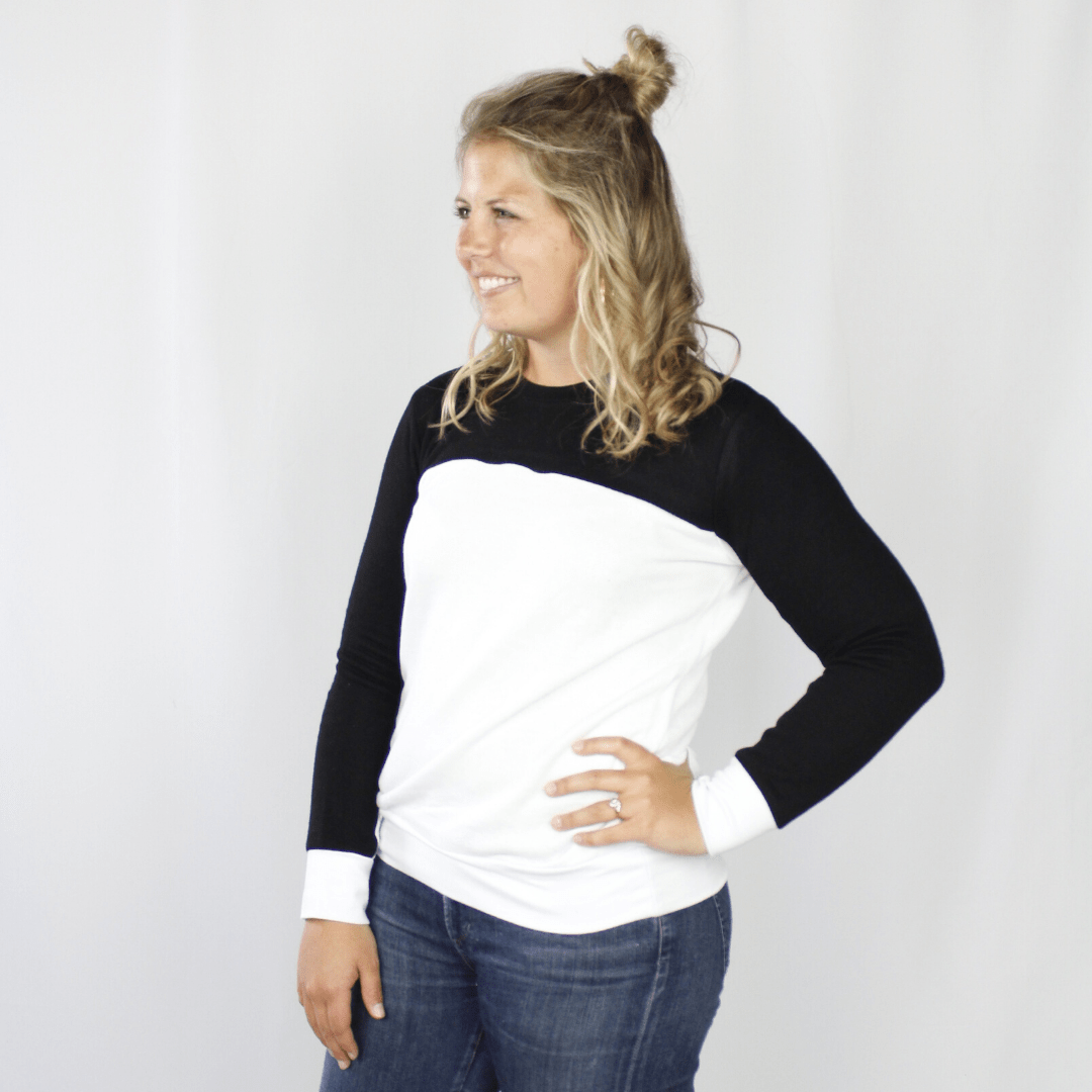 White sweatshirt with black sleeves, white wrist accents