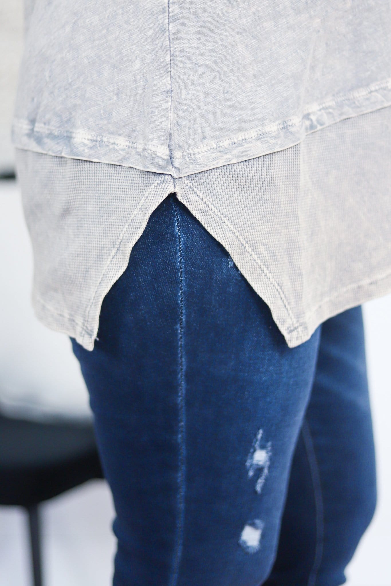 triangle cut out on waist of grey shirt