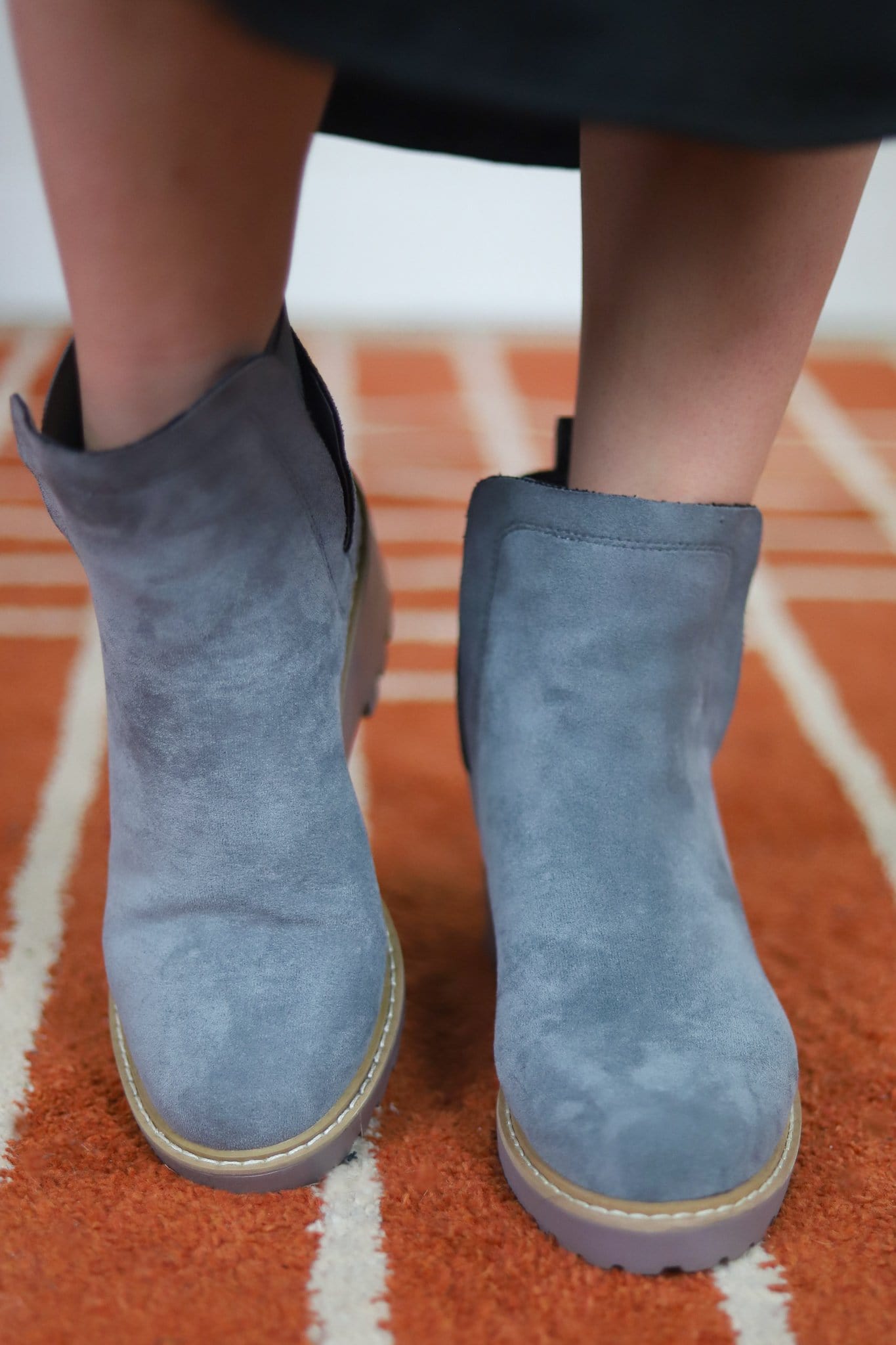 simple grey boot worn with skirt