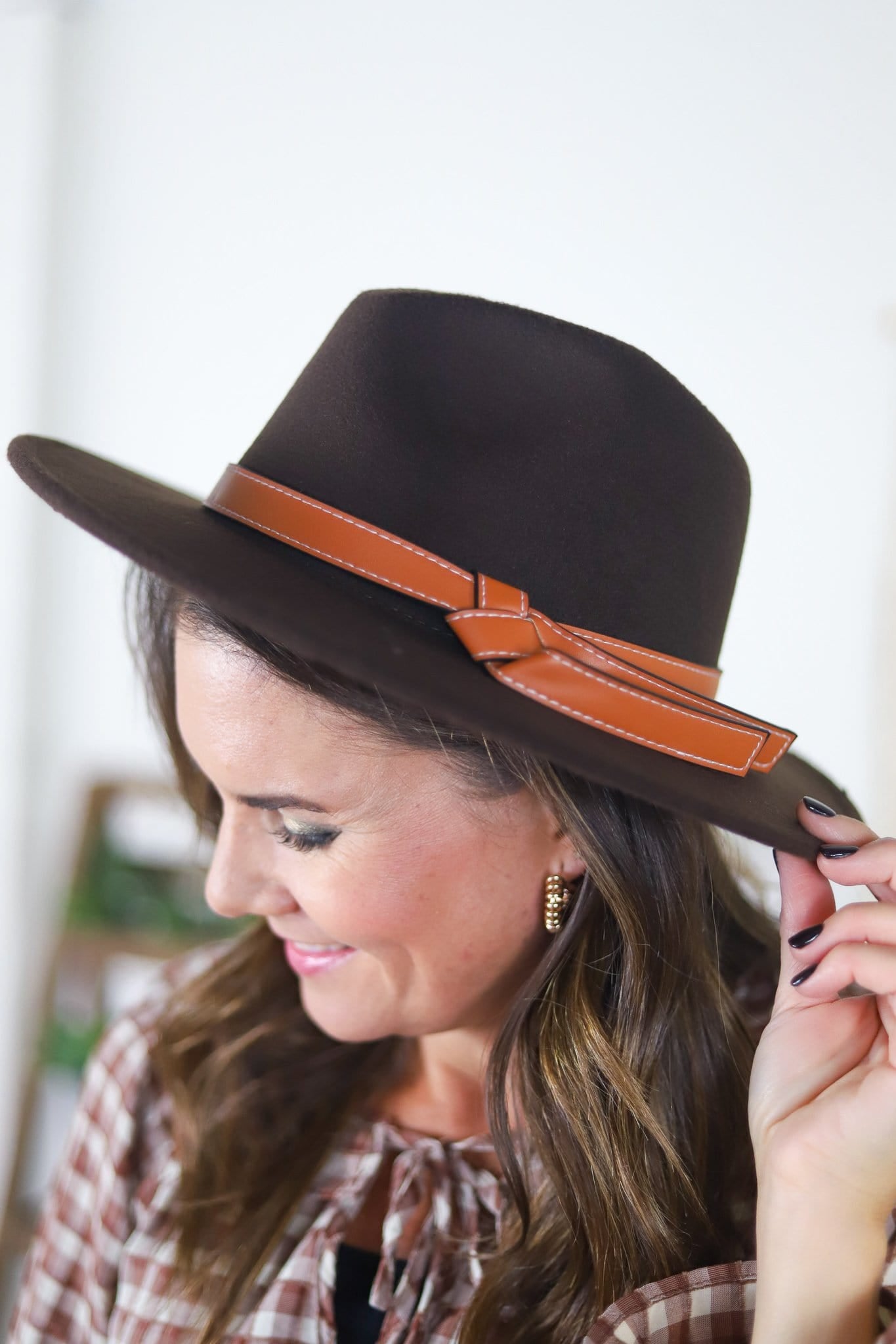 brown hat with stitched leather ribbon