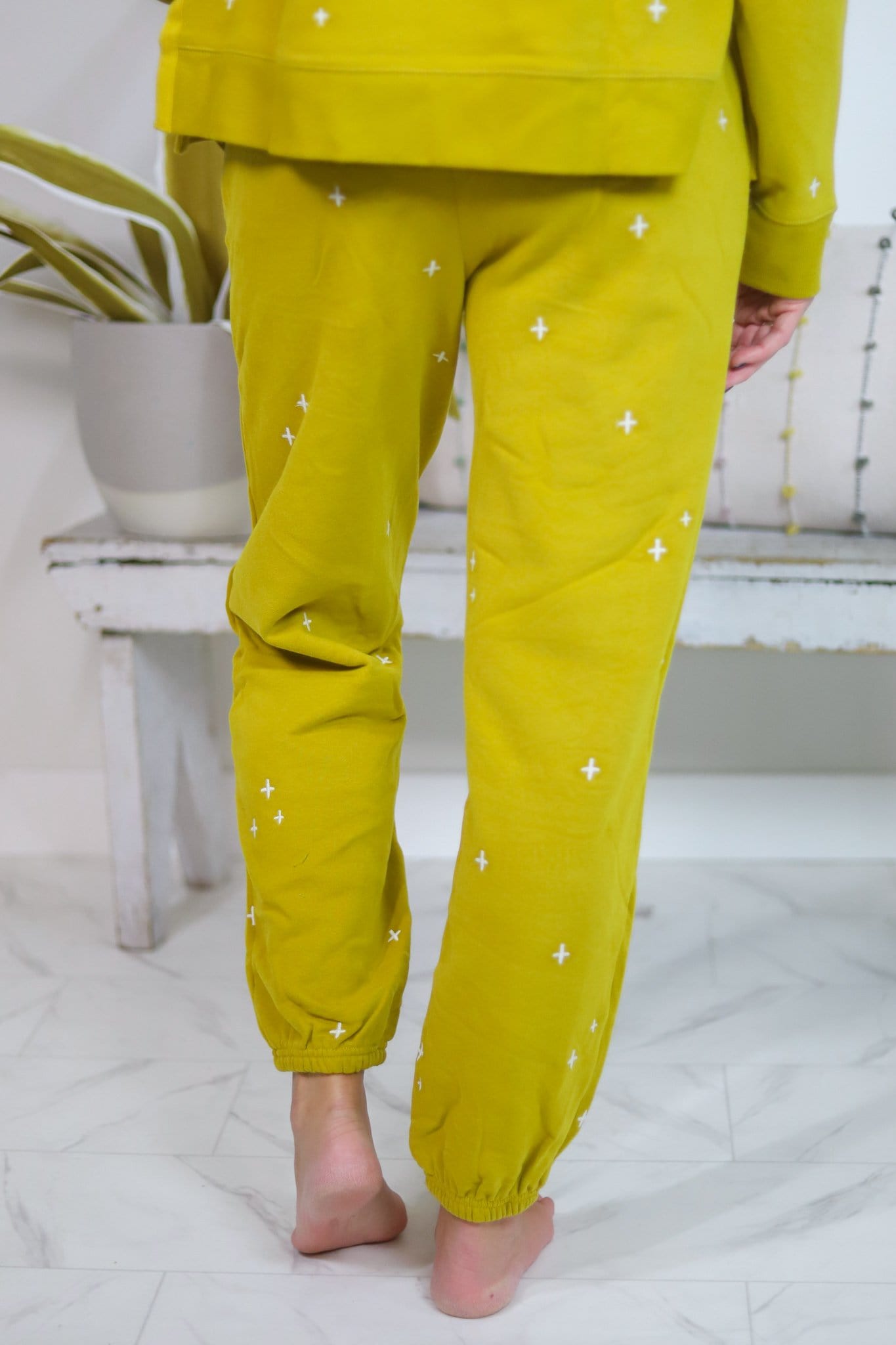 yellow pants with white pants embroidered back