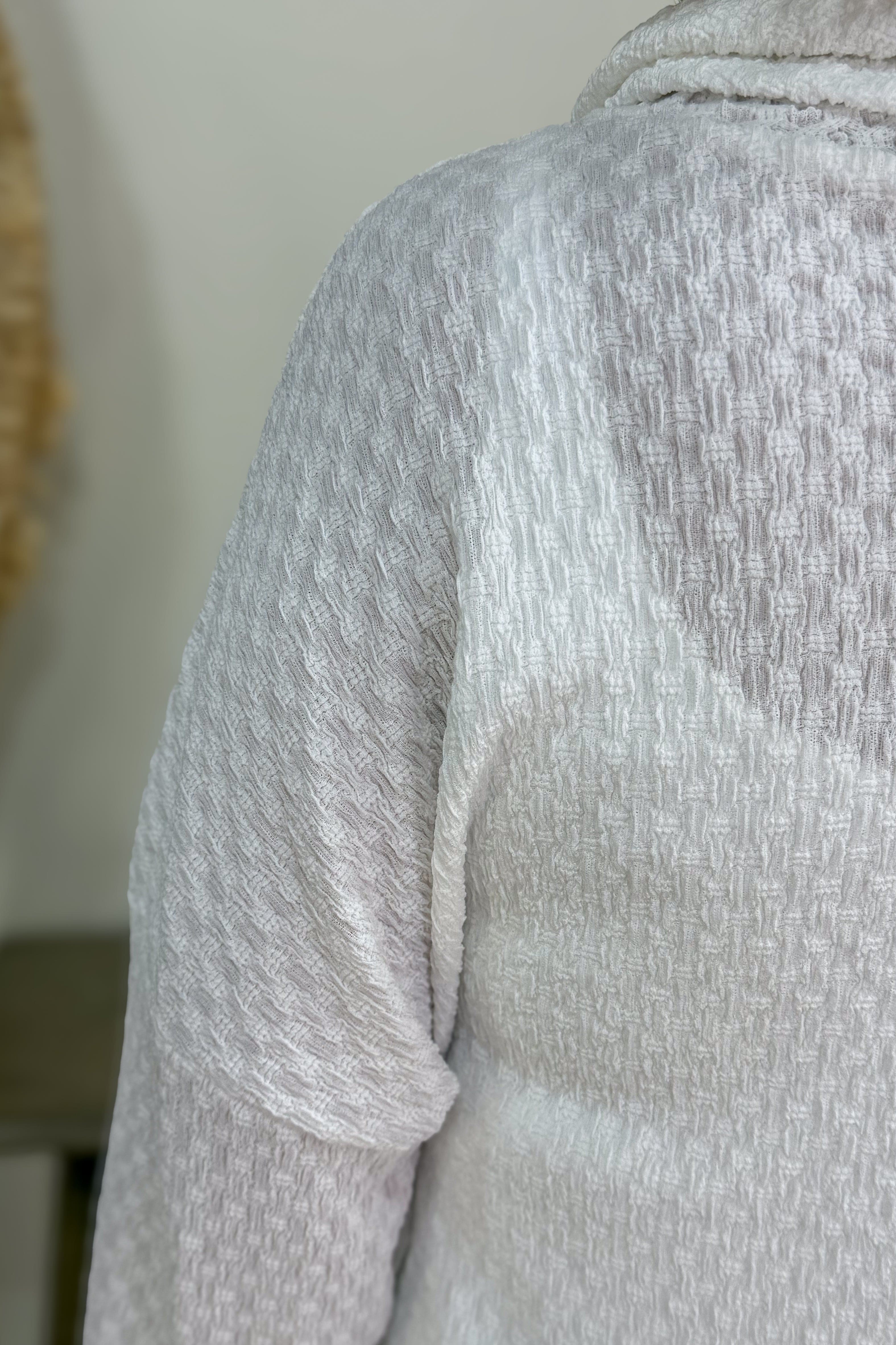 Close-up of a textured gray fabric with a blurred background