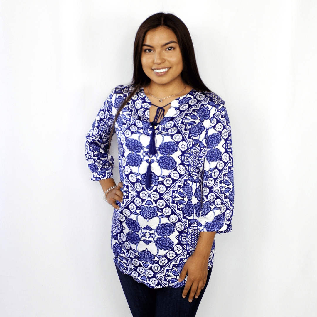 Blue and white pattered blouse, 3/4 length sleeve, tassel accent