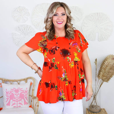 orange short sleeve shirt with colorful flowers