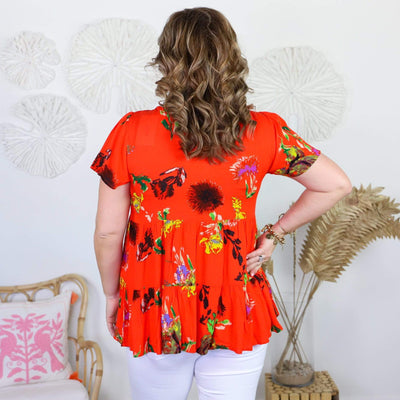 orange short sleeve shirt with colorful flowers 
