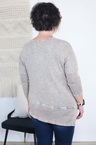 back of grey shirt with textured grey and seamed sleeves