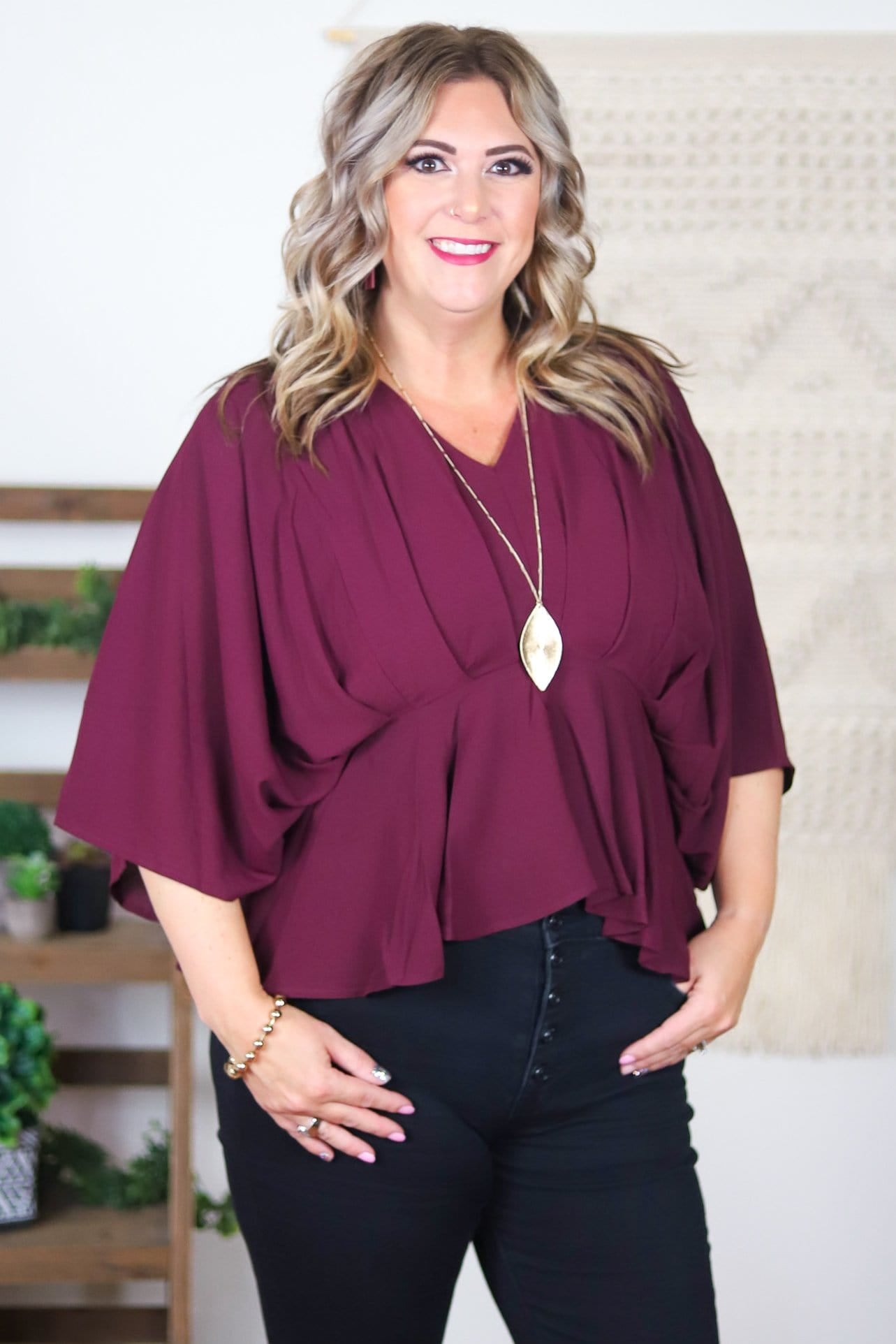 wine colored ruffled flowing cinched blouse