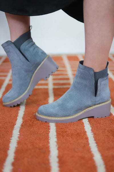 grey boots with yellow and brown sole