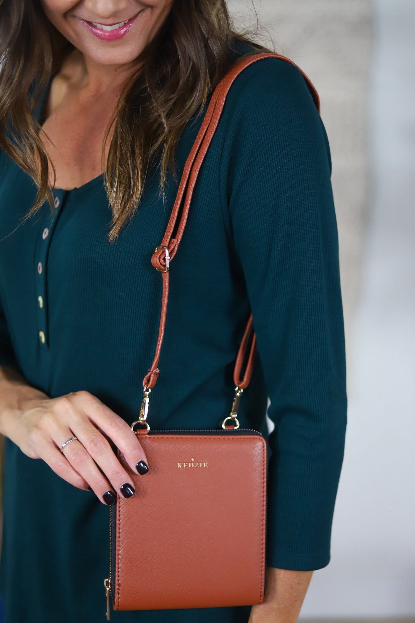brown little bag with metallic strap clips