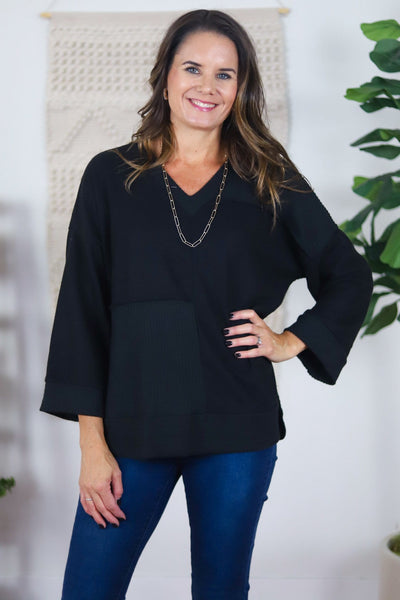 black v-neck with textured patch