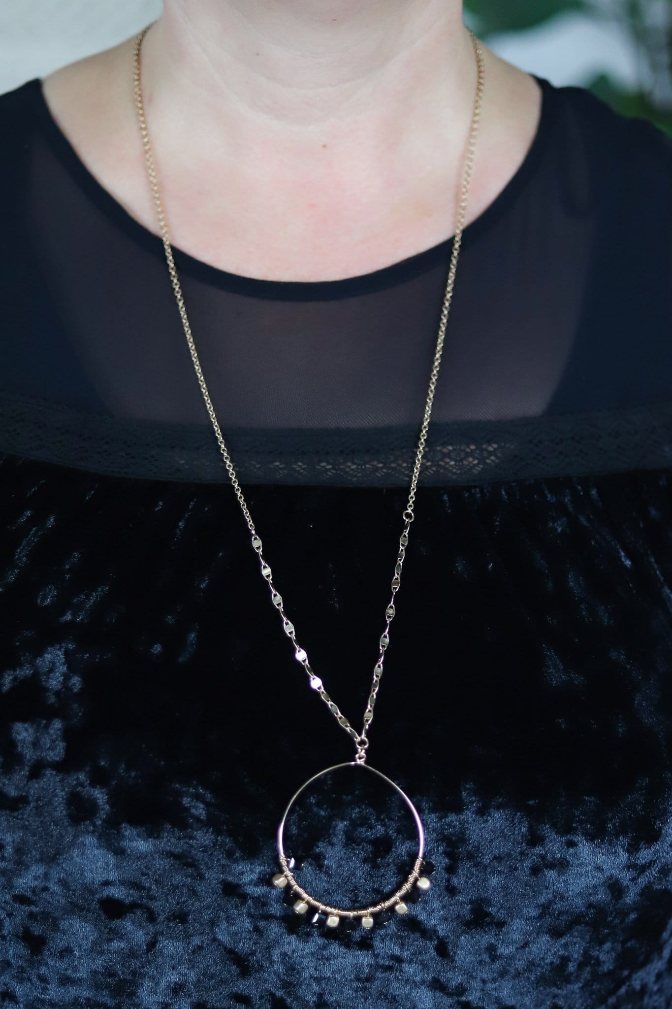 golden ring on styled chain