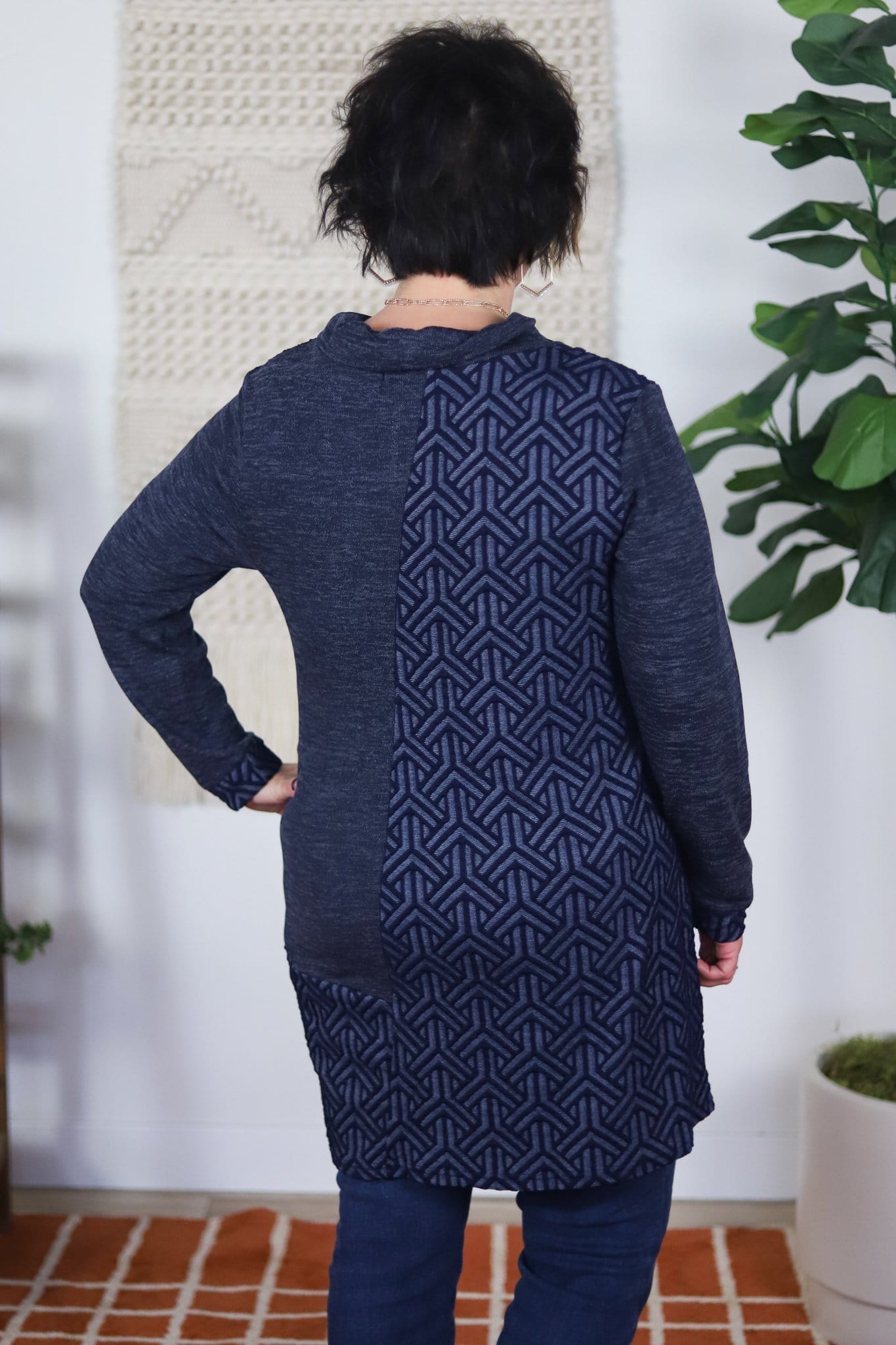 back of dark blue cowl neck with geometric pattern