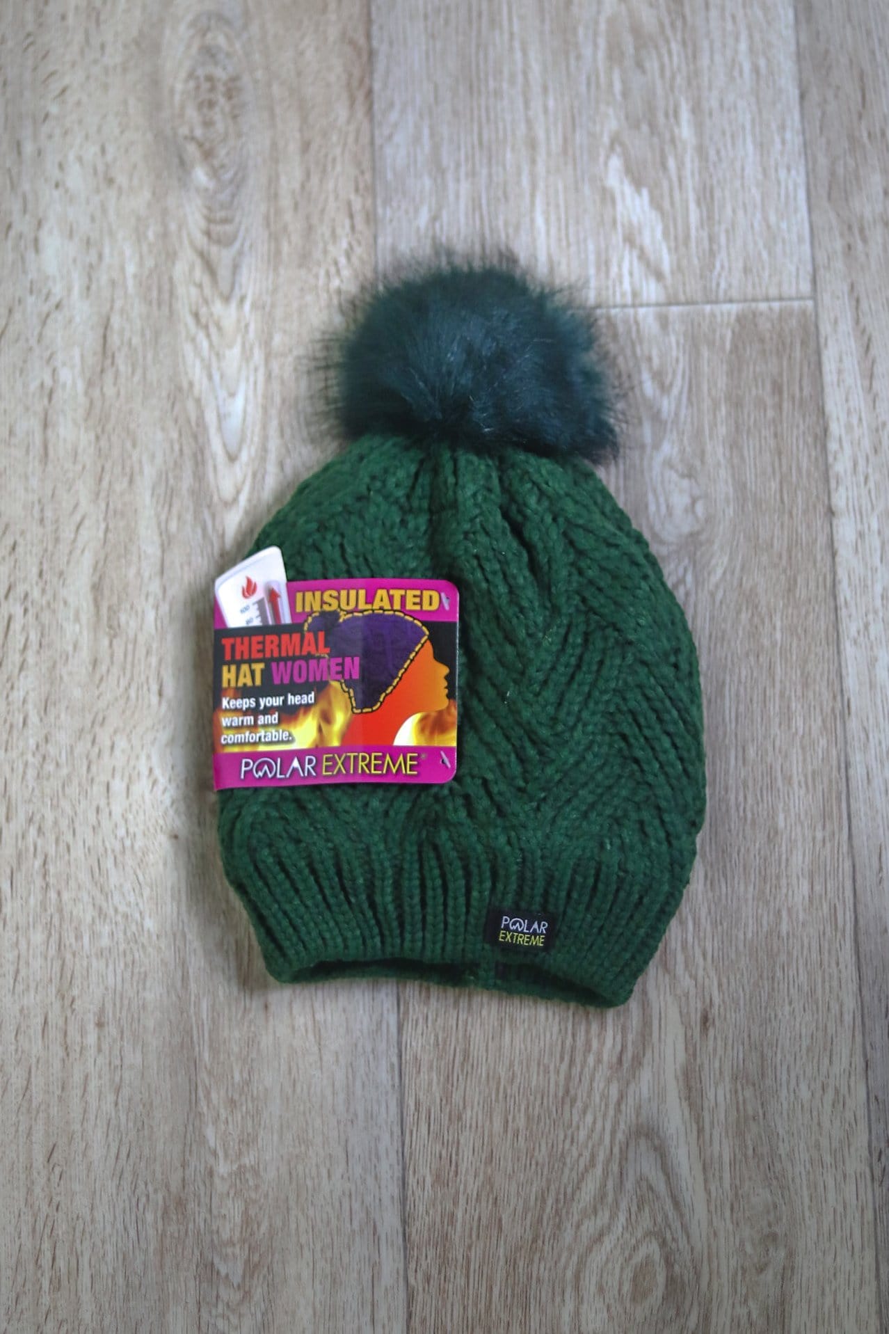 green hat with pom knitted 
