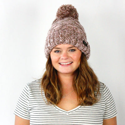 fuzzy brown pom hat on woman 
